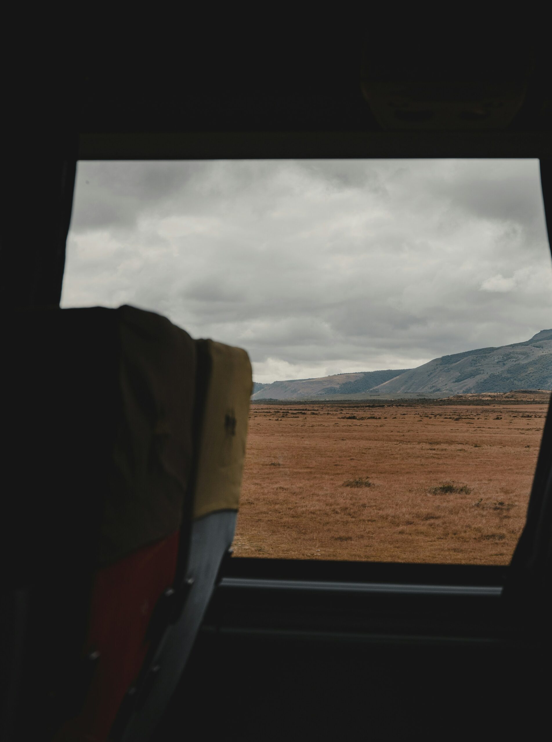 Image of inside of a bus on a cool place. https://unsplash.com/photos/a-view-of-a-field-from-a-plane-window-IIliU2RApQM?utm_content=creditShareLink&utm_medium=referral&utm_source=unsplash